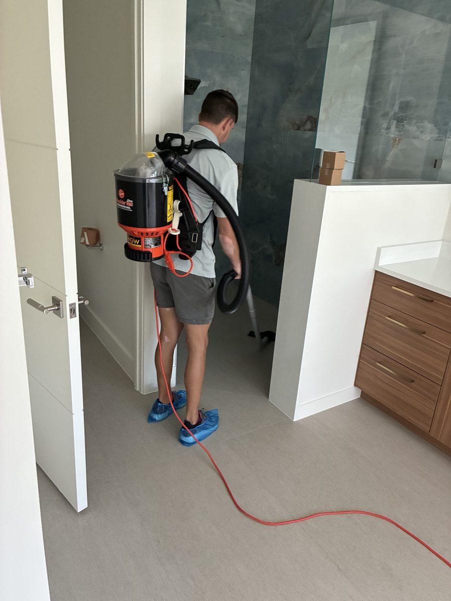 Crew member doing final detail vacuuming in a finished home